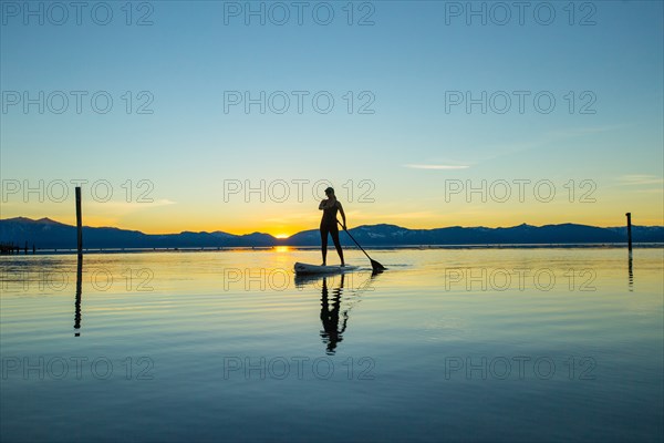 Woman on Paddle Board at Sunset, Lake Tahoe, Nevada, USA