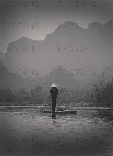 Fisherman Standing on Small Boat, Vietnam