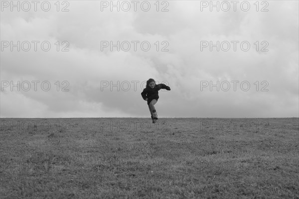 Young Girl Running in Field