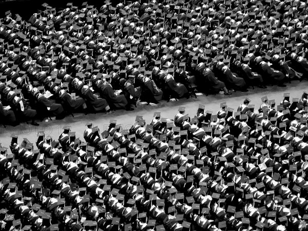 College Graduates Sitting at Graduation Ceremony