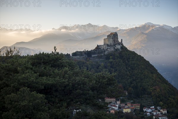 Sacra di San Michele at Sunset with Alps in Background and Village of San Pietro Below, Italy