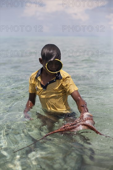 Boy Catching Octopus With Stick