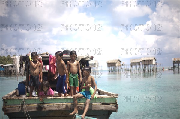 Young Children Playing at Back of Boat, Semporna, Borneo