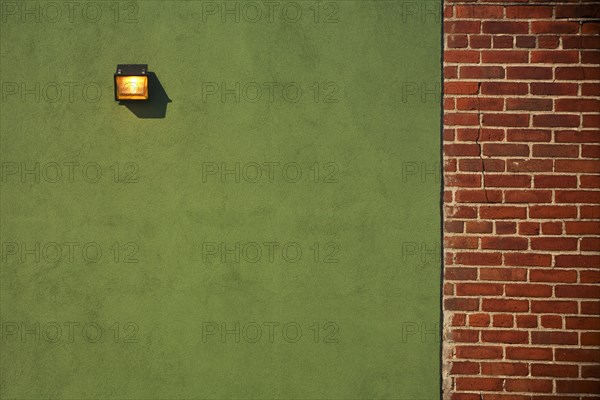 Light Fixture on Green Wall With Red Brick Wall Border