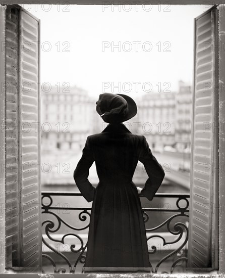 Woman Standing on Balcony, Rear View, Paris, France,