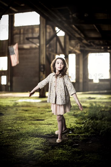 Young Girl Dancing in Abandoned Warehouse