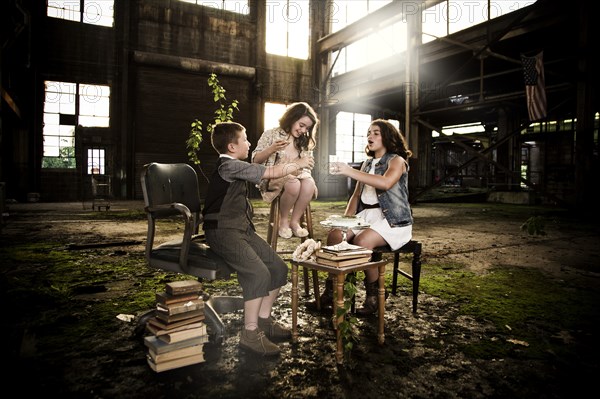 Children Having Tea Party in Abandoned Warehouse