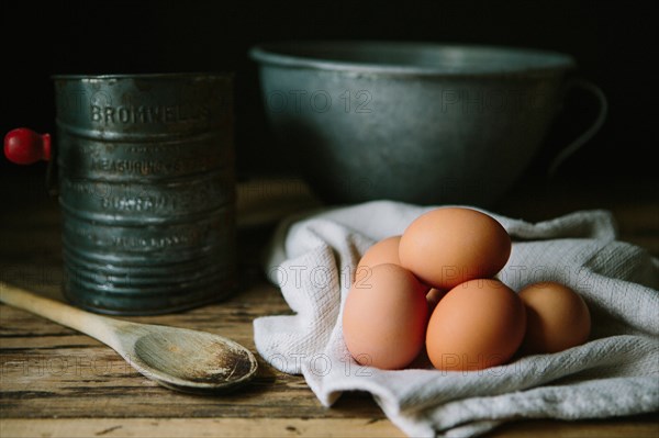 Brown Eggs with Wood Spoon, Sifter and Mixing Bowl