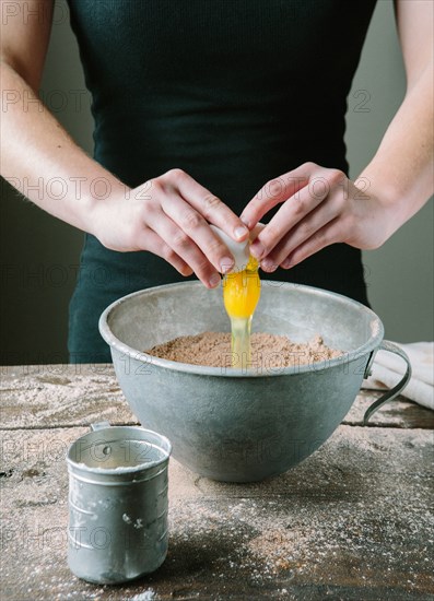 Egg Yolk Being Added to Cake Mix in Bowl