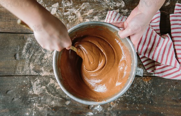 Hands Stirring Cake Batter in Bowl, High Angle View