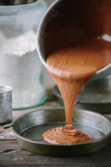 Cake Batter Being Poured into Cake Tin