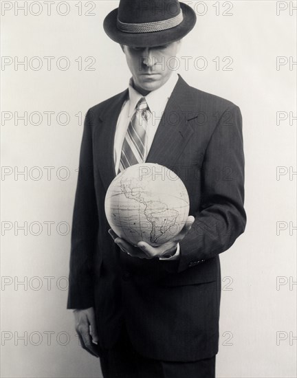 Man in Suit with Globe