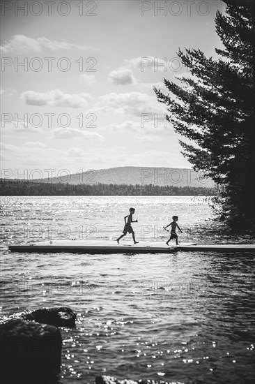 Two Boys Running on Dock