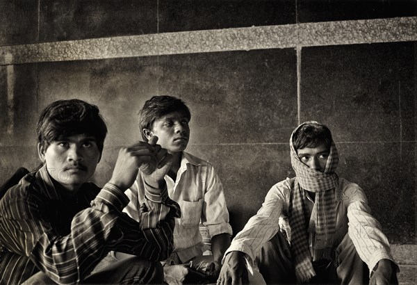 Three Young Men Sitting Together, India