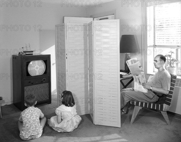 Father Reading Newspaper while Two Children Watch Television, Gottscho-Schleisner Collection, 1950