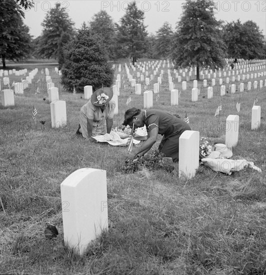 Two Women Decorating Soldier's Grave on Memorial Day, Arlington National Cemetery, Arlington, Virginia, USA, Esther Bubley for Office of War Information, May 1943