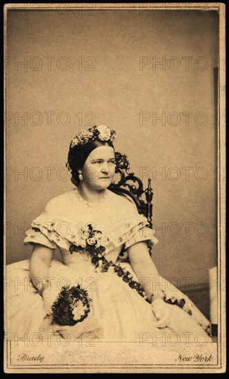 Mary Todd Lincoln, Seated Portrait wearing Ball Gown and Holding Bouquet of Flowers, Photograph by Mathew Brady, Brady-Handy Photograph Collection, 1861