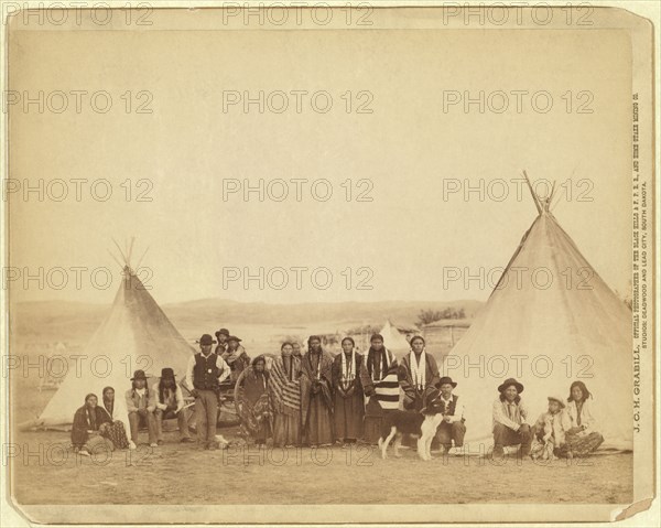 Group of Miniconjou Men, Women and Children, Group Portrait between two Tipis, Pine Ridge Reservation, South Dakota, USA, Photograph by John C.H. Grabill, 1890