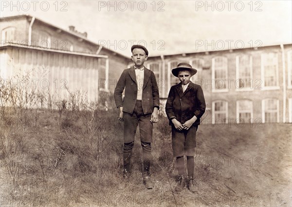 Arthur Shelly (left), 14 years old and Tommy Ashville, about 11 years old, Textile Mill Workers, Full-Length Portrait, Chester, South Carolina, USA, Photograph by Lewis Wickes Hine, November 1908