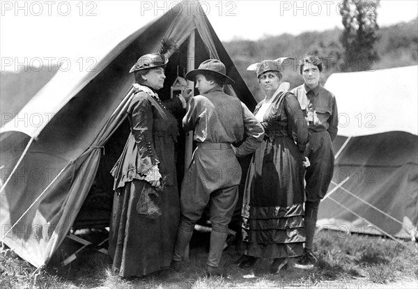 Mary Dimmick Harrison, wife of President Benjamin Harrison and her daughter Elizabeth Harrison Walker with Mrs. Green and probably her daughter, Helen standing at tent of Emergency Services Corps camp where young women were trained in shooting, military drills, hiking and other activities by Army officers, on the estate of Mr. and Mrs. Edward Hewitt, Passaic County, New Jersey, USA, Bain News Service, 1916