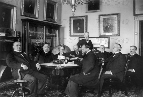 U.S. President William McKinley and his Cabinet, L-R: William McKinley, Secretary of the Treasury Lyman J. Gage, Attorney General John W. Griggs, Secretary of the Navy John D. Long, Secretary of Agriculture James Wilson (standing), Secretary of State John Hay, Secretary of the Interior Cornelius N. Bliss, Secretary of War Russell A. Alger, and Postmaster General Charles E. Smith, Washington, D.C., USA, 1898