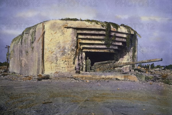 U.S. Soldier Standing at Knocked Out Crisbecq Battery near Utah Beach, Saint-Marcouf, Normandy, France, June 1944