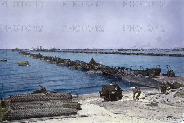 U.S. Military Vehicles crossing Pontoon Bridge to Omaha Beach from Temporary Mulberry Harbour A, Normandy, France, June 16, 1944