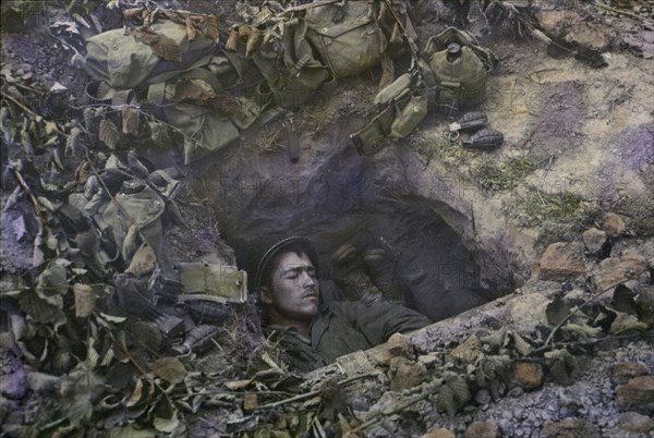 Two U.S. Infantrymen Share a Foxhole near Frontlines after the Allied Invasion of Normandy, Near Bayeux, Calvados, France, July 1944