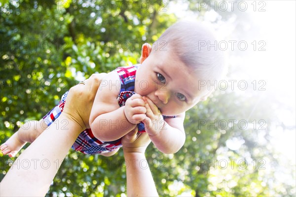 Infant Boy Being Held up in the Air