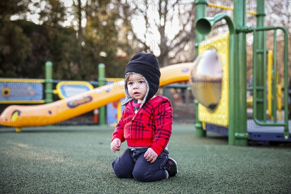 Young Boy Kneeling at Playground