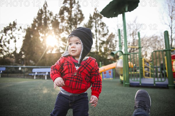 Young Boy at Playground with Sun Flare in Background