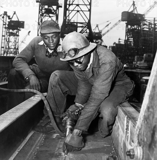 A Chipper Removing Excess Metal from a Welded Seam during Construction of the Liberty Ship Frederick Douglass, Bethlehem-Fairfield Shipyards, Baltimore, Maryland, USA, Roger Smith, U.S. Office of War Information, May 1943
