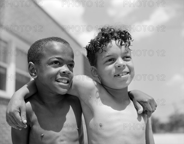 Two Young Boys with Arms over each other's Shoulders, Frederick Douglass Housing Project, Anacostia Neighborhood, Washington DC, USA, Photograph by Gordon Parks, June 1942
