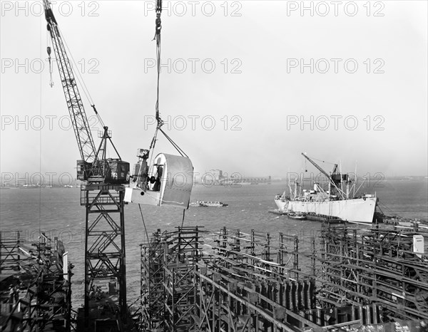 Large Blower being Hoisted into place during Construction of Liberty Ship Frederick Douglass, Bethlehem-Fairfield Shipyards, Baltimore, Maryland, USA, Roger Smith, U.S. Office of War Information, May 1943