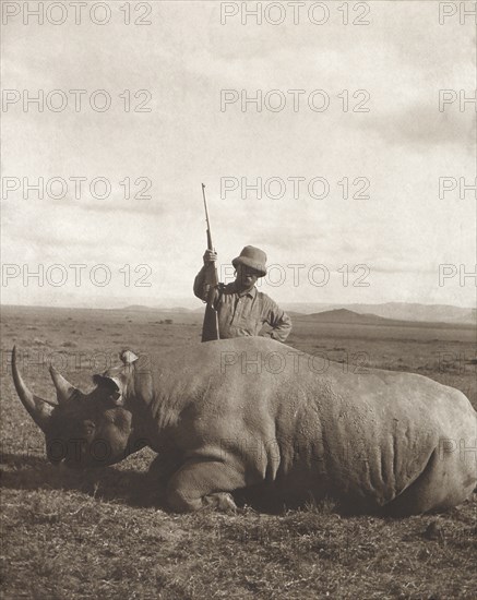 Former U.S. President Theodore Roosevelt Standing over Rhino he has shot while on Extended African Safari, Smithsonian-Roosevelt African Expedition, Photograph by Edward Van Altena, 1910
