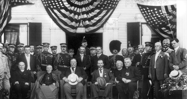 U.S. President William Howard Taft (seated center), Charles Evans Hughes (seated right), Cardinal James Gibbons (seated left), and other unidentified men, Group Portrait during visit to Catholic Summer School of America, Cliff Haven, New York, USA, July 7, 1909