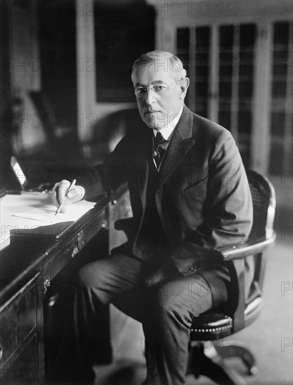 Woodrow Wilson (1856-1924) 28th President of the United States 1913-1921, Three-Quarter Length Portrait seated at desk in White House Oval Office, Washington, D.C., USA, Photograph by  Harris & Ewing, 1913-1917