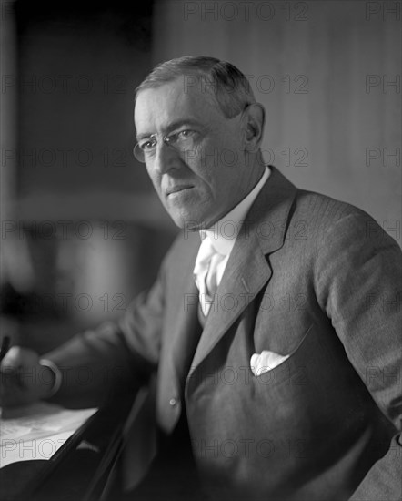 Woodrow Wilson (1856-1924) 28th President of the United States 1913-1921, Half-Length Portrait seated at desk in White House Oval Office, Washington, D.C., USA, Photograph by  Harris & Ewing, 1913-1917