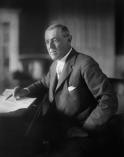 Woodrow Wilson (1856-1924) 28th President of the United States 1913-1921, Half-Length Portrait seated at desk in White House Oval Office, Washington, D.C., USA, Photograph by  Harris & Ewing, 1913-1917