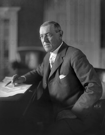 Woodrow Wilson (1856-1924) 28th President of the United States 1913-1921, Three-Quarter Length Portrait seated at desk in White House Oval Office, Washington, D.C., USA, Photograph by  Harris & Ewing, 1913-1917