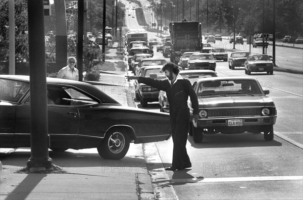 Man Directing Line of Cars at Gas Station during Oil Crisis, Maryland, USA, photograph by Thomas J. O'Halloran, June, 15 1979