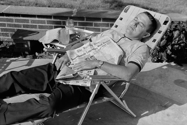 Man Sleeping in Lounge Chair with Newspaper across his Chest, Washington, D.C., USA, photograph by Thomas J. O'Halloran, August 1962