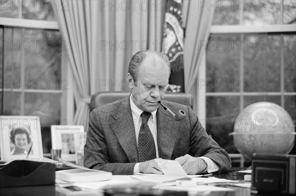 U.S. President Gerald Ford working at his Desk, smoking a Pipe, White House, Washington, D.C., USA, photograph by Marion S. Trikosko, February 6, 1975