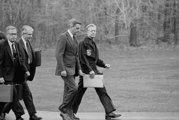 U.S. President Jimmy Carter, Vice President Walter Mondale, Secretary of State Cyrus Vance, and Secretary of Defense Harold Brown after disembarking from their helicopter to meet about Iran Hostage Crisis, Camp David, Maryland, USA, photograph by Marion S. Trikosko, November 23, 1979