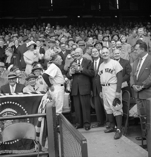 U.S. President Dwight Eisenhower getting ready to Toss out First Ball at Opening Day Baseball Game between Washington Senators and New York Yankees, Yankees Manager Casey Stengel to right, Senators Manager Chuck Dressen to left, Washington, D.C., USA, photograph by Warren K. Leffler, April 17, 1956