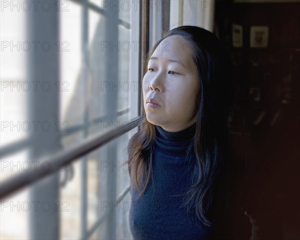 Portrait of Contemplative Woman Looking out Window