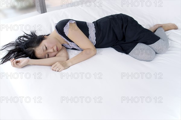 Depressed Woman Laying on Bed