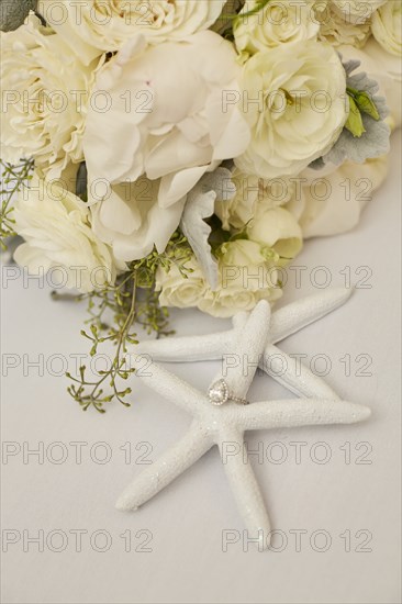 Engagement Ring on Starfish Decoration and Flowers