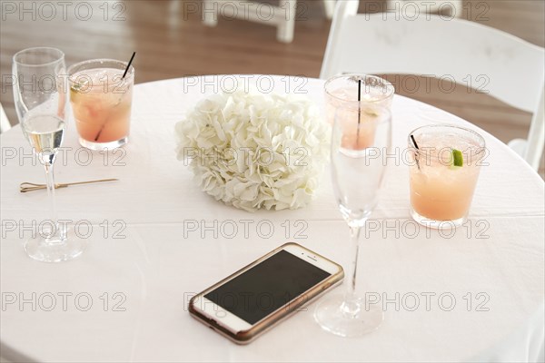 Cocktails and Phone on Wedding Reception Table