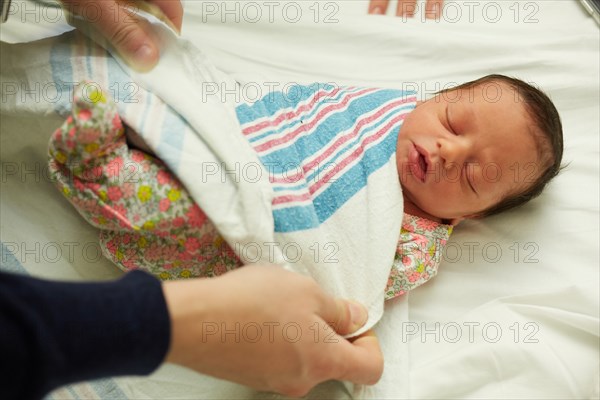 High Angle View of Newborn Baby Girl Being Wrapped in Blanket